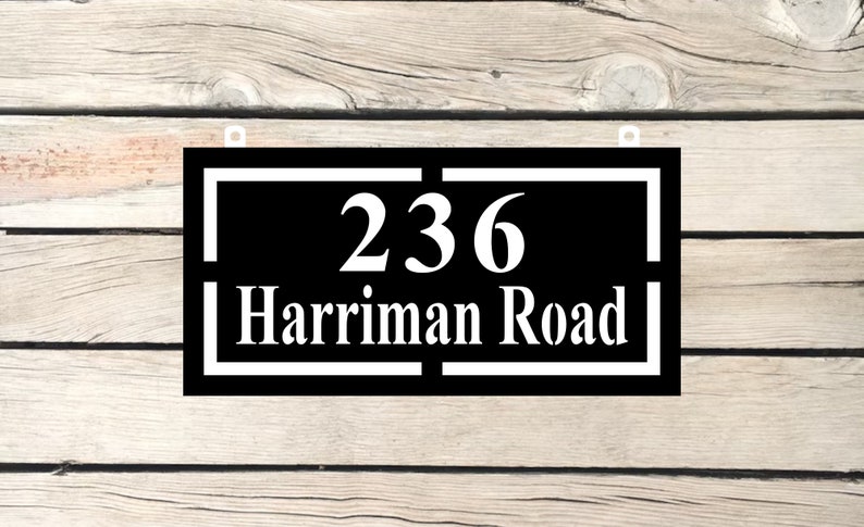 May include: Black and white house number sign with the number 236 and the street name Harriman Road.