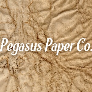 May include: A close-up of a crumpled, brown paper background with a white text overlay that reads "Pegasus Paper Co."