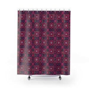 May include: A patterned shower curtain with a repeating design of squares in shades of burgundy, pink, and purple. Each square features a circular mandala pattern and a crescent moon. The curtain hangs from a metal rod.