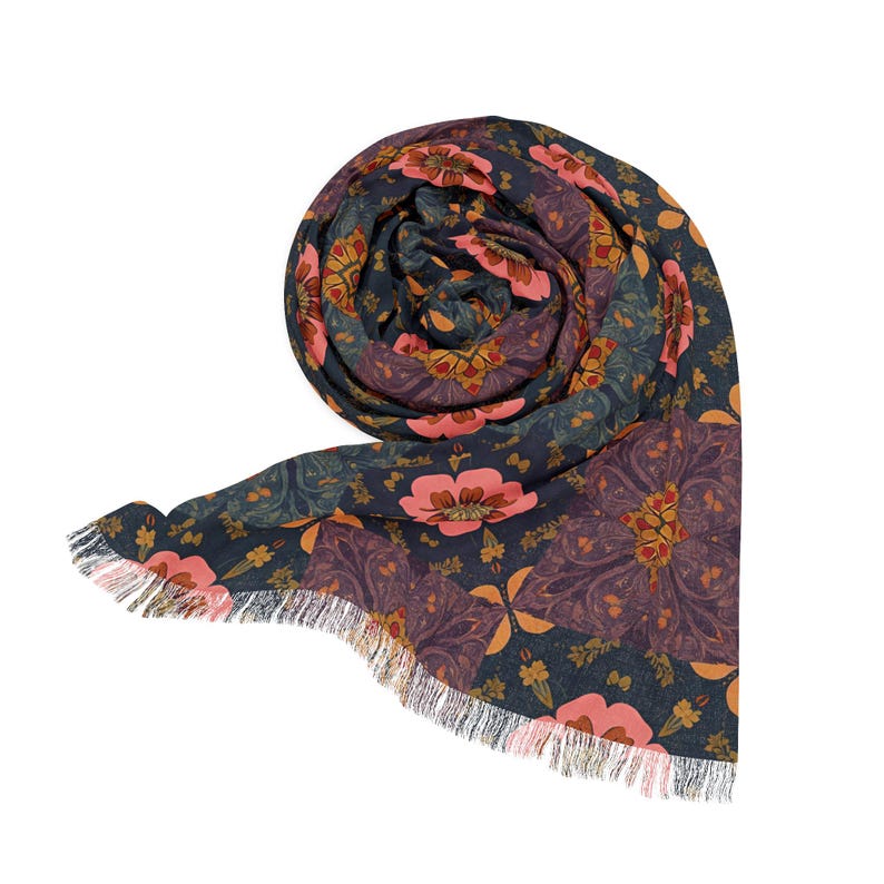 May include: Rolled scarf with a floral pattern in shades of navy, purple, peach, and gold. The scarf has a fringed edge. The floral design features large, stylized flowers and intricate details.