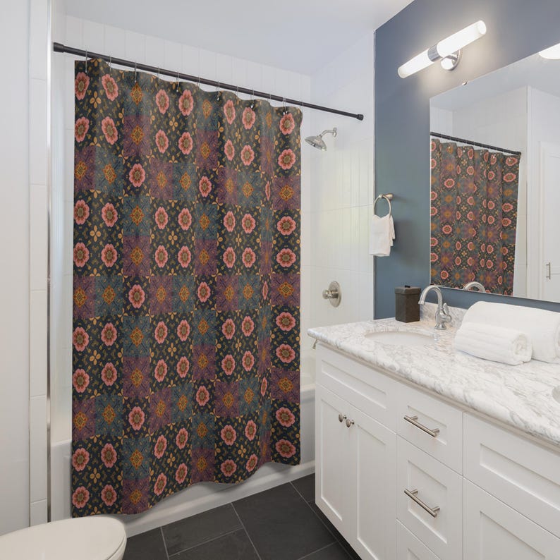 May include: A patterned shower curtain with a repeating floral design in shades of pink, blue, and gold on a dark background. The curtain hangs in a bathroom with white fixtures and a dark tile floor.