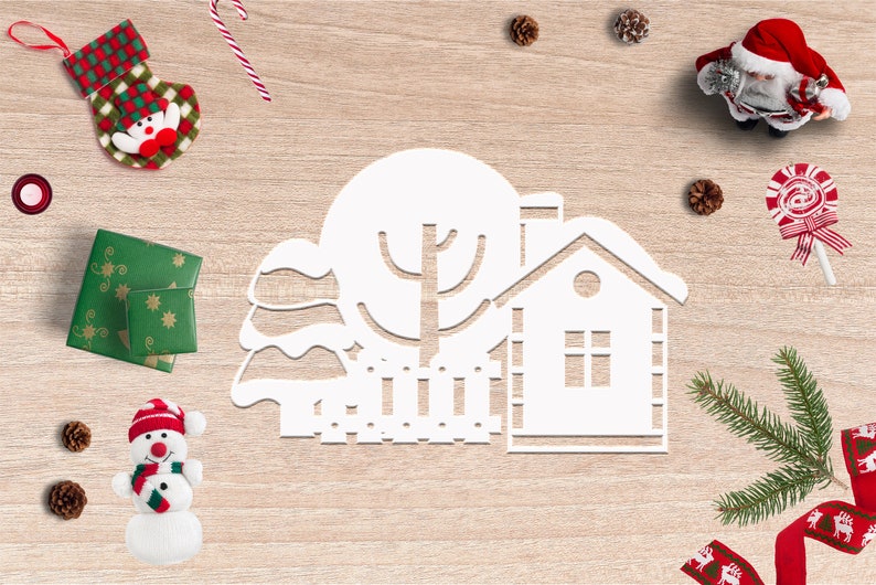 May include: White paper cut-out of a winter scene with a house, tree, and fence. The scene is surrounded by Christmas decorations, including a stocking, candy canes, pine cones, and a snowman.