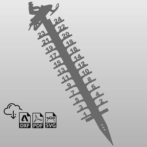 May include: A gray metal ruler with a snowmobile silhouette at the top. The ruler is marked with numbers from 1 to 24.