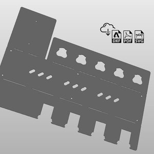 May include: A gray metal wall-mounted organizer with six round holes and five rectangular slots. The organizer is designed to hold various items, such as tools, utensils, or other small objects.