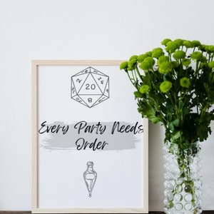 May include: A framed print with a black and white illustration of a twenty-sided die and a potion bottle. The text "Every Party Needs Order" is written in black cursive font on a gray background.
