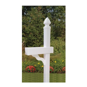 May include: White vinyl mailbox post with a decorative finial and a mailbox holder. The post is installed in a garden setting with green grass and flowers.