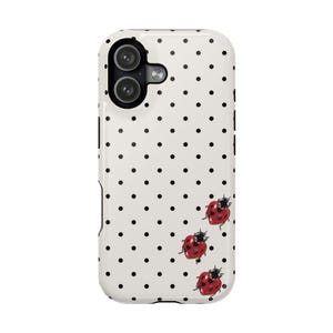 May include: A white phone case with a black polka dot pattern and three red ladybug illustrations. The phone case has a dual-lens camera cutout.