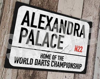 May include: A white sign with black lettering that reads "Alexandra Palace" and "Home of the World Darts Championship". The sign also has a red number "N22" on it. The sign is weathered and has a distressed look.