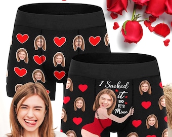 May include: Black boxer briefs with a repeating pattern of red hearts and a woman's face. One pair has the text "I Sucked it so it's Mine" and a graphic of a woman in a red swimsuit. The image also shows red roses.
