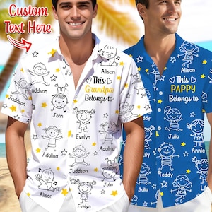 May include: Two short-sleeved button-down shirts. One is white with a pattern of children, stars, and the text "This Grandpa Belongs to" and names. The other is blue with a similar design and the text "This Pappy Belongs to".