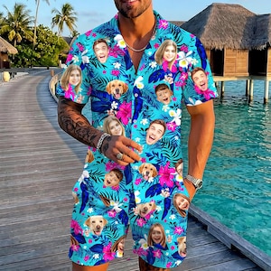 May include: A short-sleeve button-down shirt and matching shorts set in a bright turquoise blue color. The fabric features a tropical pattern of dark blue palm leaves, vibrant pink hibiscus flowers, and white blossoms interspersed with custom photo faces.