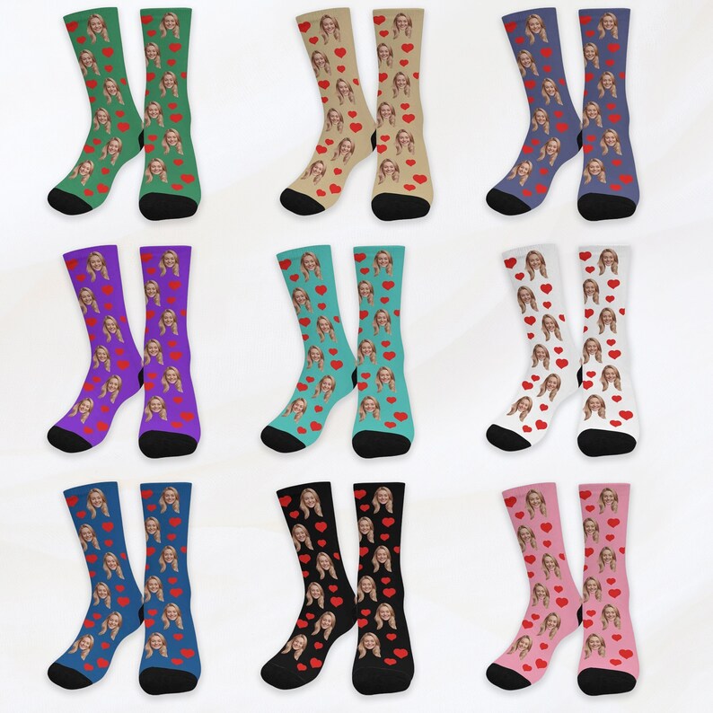 May include: A set of 10 pairs of socks with a variety of colors and patterns. Each pair features a repeated image of a person's face with red hearts.