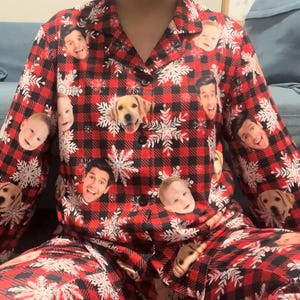 May include: Red and black plaid pajama set with a snowflake pattern and various faces printed on it.