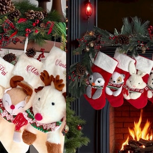 May include: Festive Christmas stockings with animal faces, such as a bear and reindeer, hang above a fireplace. The red stockings have white cuffs and embroidered names. The mantel is decorated with greenery and pine cones.