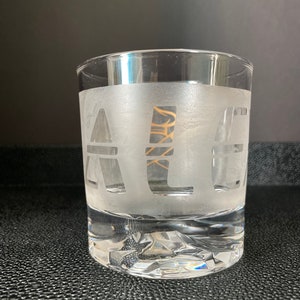May include: A frosted glass with the word "ALE" etched into the side.