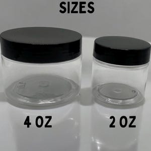 May include: Two clear plastic jars with black lids. The larger jar is labeled "4 oz" and the smaller jar is labeled "2 oz".