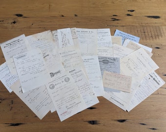 May include: A collection of vintage documents and receipts, some with handwritten text, on a wooden surface. The documents are in various sizes and colors, and some have decorative borders or seals.