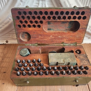 May include: A set of three ceramic mugs with a speckled, matte finish. The mugs are in shades of cream, light gray, and dark gray. Each mug has a simple, minimalist design, perfect for coffee or tea.