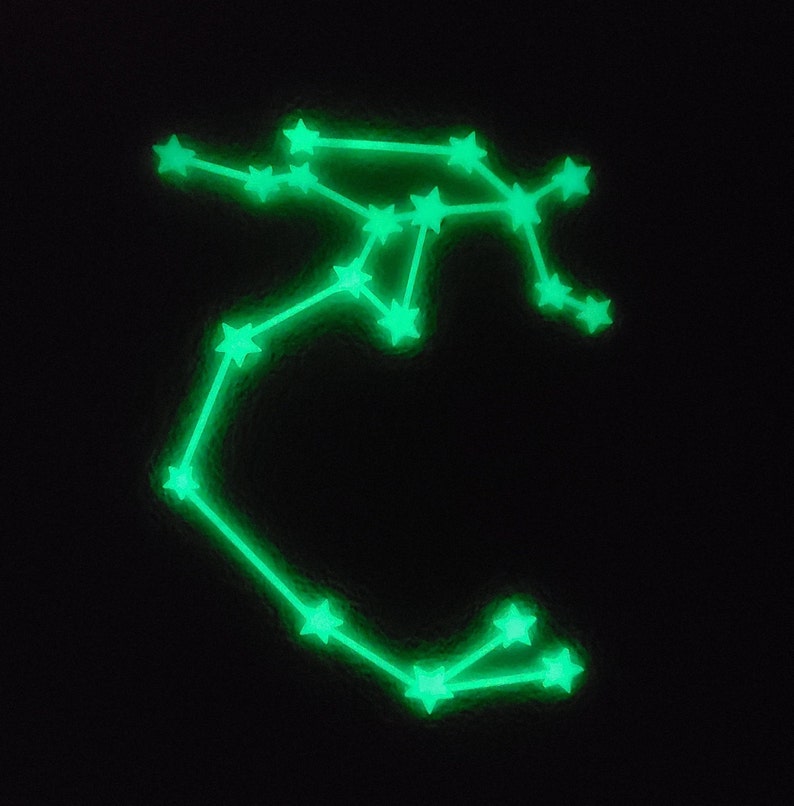 May include: A green glow-in-the-dark constellation wall decal in the shape of the zodiac sign Sagittarius.