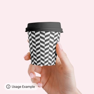May include: A black and white chevron patterned paper coffee cup with a black lid.