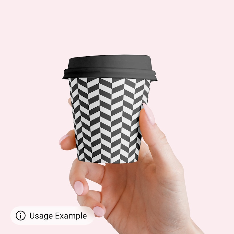 May include: A black and white chevron patterned paper coffee cup with a black lid.