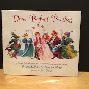 May include: A children's book cover with the title "Three Perfect Peaches" in pink lettering. The cover features an illustration of a group of people in colorful clothing, including a king and queen, dancing around a peach tree.