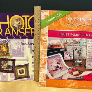 May include: Two books about photo transfer for fabric projects. The book on the left is titled "The Photo Transfer Handbook" by Jean Ray. The book on the right is titled "EQ Printables Perfect for Photo Projects" and features inkjet fabric sheets. Both books have colorful covers.