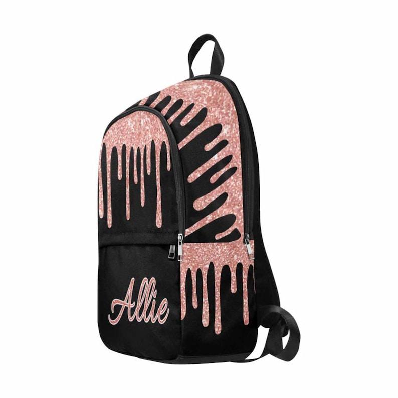 May include: Black backpack with a rose gold glitter drip design and the name "Allie" written in rose gold script.