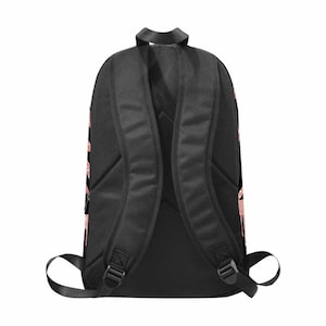 May include: Black backpack with adjustable straps. The backpack has a rose gold design on the sides.