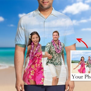 May include: Pale blue button-down shirt with a custom photo design. The shirt features a beach scene with a couple wearing leis. A smaller image in the corner says "Your Photo".