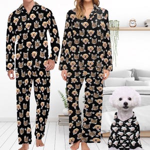 May include: Matching black pajamas with a repeating pattern of dog and cat faces. The pajamas are shown on two people and a dog.