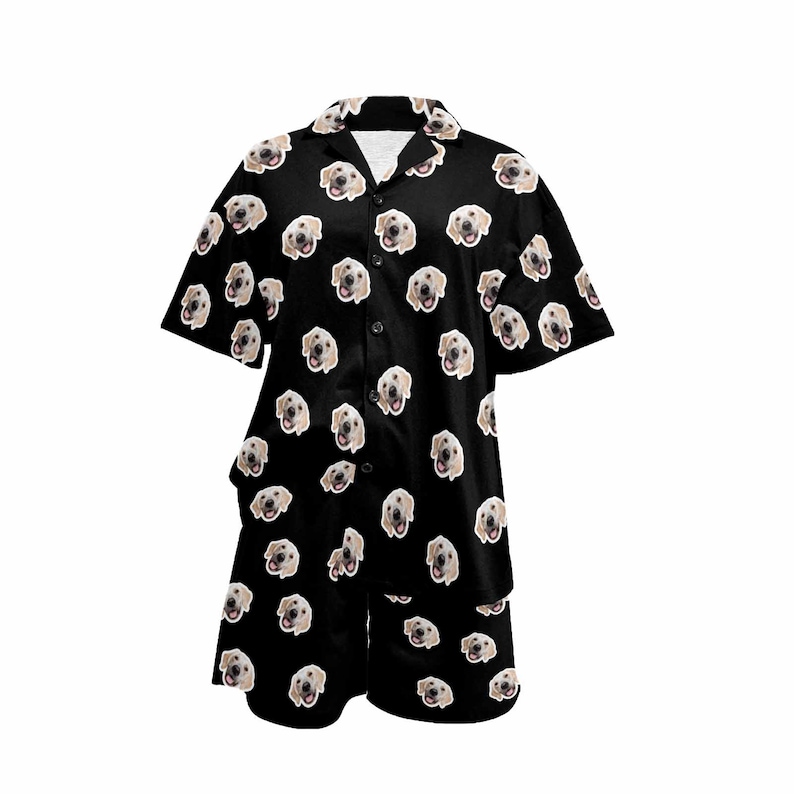 Peut inclure: Ensemble pyjama noir avec une chemise &agrave; manches courtes boutonn&eacute;e et un short assorti. Le tissu pr&eacute;sente un motif r&eacute;p&eacute;t&eacute; de visage de chien.