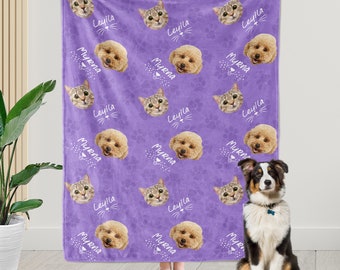 May include: Purple fleece blanket with a repeating pattern of paw prints and the names "Leyila" and "Myrna" in white text. The blanket features images of a cat and a dog.