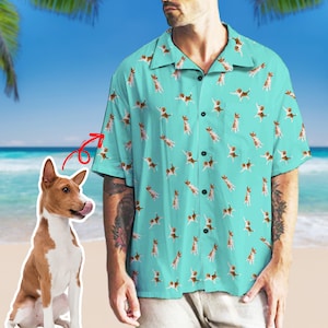May include: A turquoise blue button-up shirt with a repeating pattern of a brown and white dog. The dog is in a playful pose with its tongue sticking out.