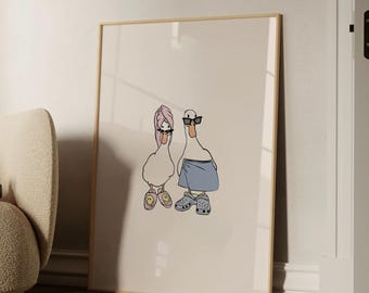 May include: A framed art print featuring two cartoon ducks. One duck wears a pink towel and sunglasses, the other wears sunglasses, a blue towel, and Crocs. The ducks are drawn in a minimalist style.