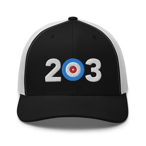May include: Black and white trucker hat with a white mesh back. The front of the hat features a white embroidered design of the numbers 203 with a blue and red circle in between the numbers.