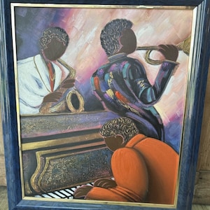 May include: A framed painting depicting three musicians playing jazz. The musicians are painted in a stylized, abstract style with vibrant colors. The painting features a saxophone player, a trumpet player, and a pianist. The painting is set against a background of a purple and pink sunset.