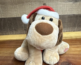 Peluche animado musical de Hallmark con forma de perro: Jingle Tail Pup, ladra y mueve la cola.