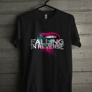 May include: Black t-shirt with a graphic of a pink and red mouth with a blue tongue sticking out. The text "FALLING IN REVERSE" is printed in white below the mouth.