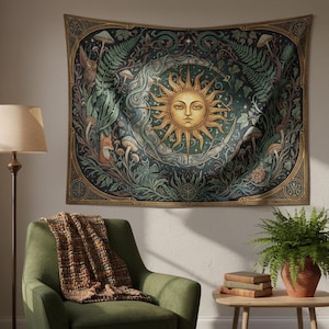 May include: A tapestry featuring a central sun design with a face, surrounded by a circular pattern of plants, mushrooms, and animals in shades of green, gold, and blue. The tapestry is hanging on a wall above a green armchair.