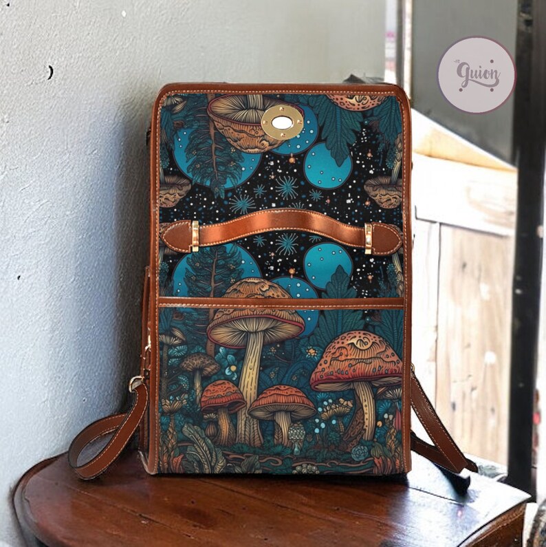 May include: A brown leather backpack with a blue and green mushroom print. The backpack has a front pocket and adjustable straps.