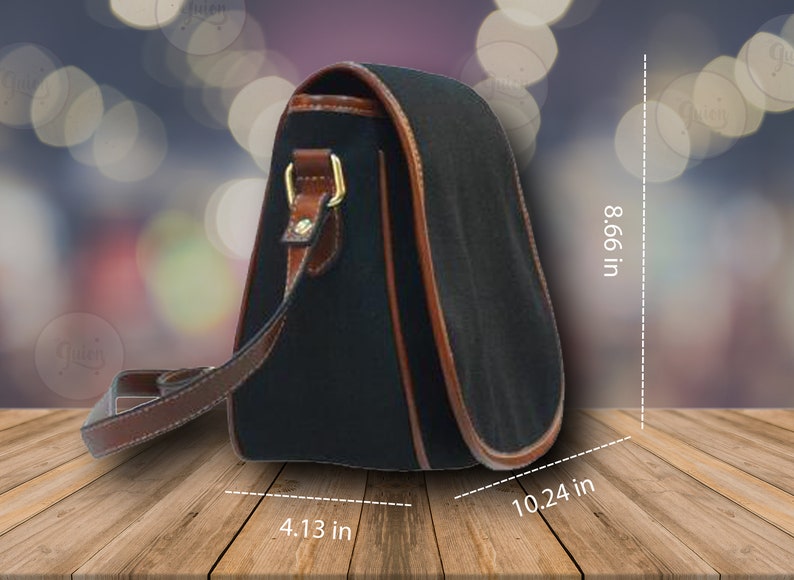 May include: Black shoulder bag with brown leather trim and strap. The bag measures 10.24 inches wide, 8.66 inches high, and 4.13 inches deep. Features gold-colored hardware and a curved design.
