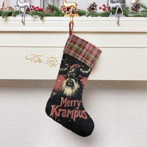 May include: Black Christmas stocking with a Krampus graphic and the text "Merry Krampus." The stocking has a red and green plaid cuff. The Krampus illustration features a horned creature with a long white beard and a menacing expression.