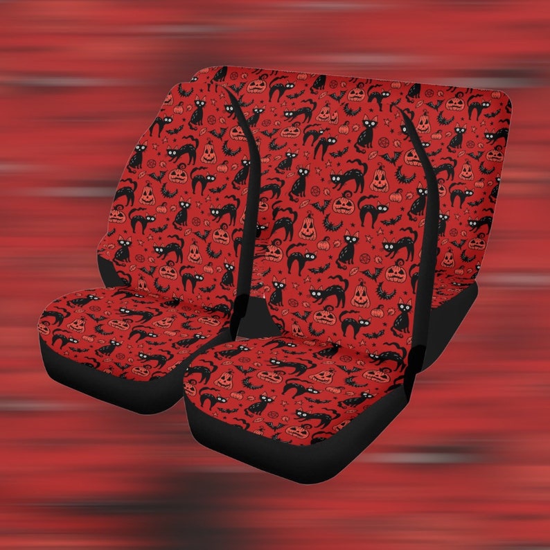 May include: Set of three red car seat covers with a black cat and pumpkin Halloween pattern.