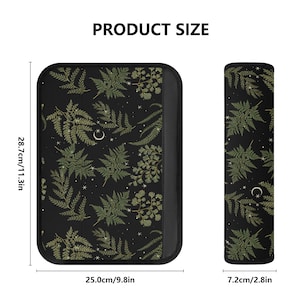 May include: A black and green fern and moon print laptop sleeve with a zipper closure. The sleeve measures 11.3 inches tall and 9.8 inches wide. A matching wrist rest is also shown, measuring 2.8 inches wide.