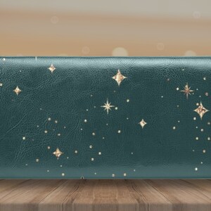 May include: A dark green leather wallet with a gold star pattern.
