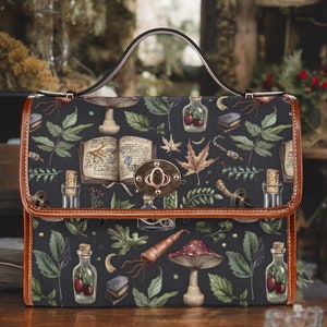 May include: A black satchel bag with a brown leather trim and a metal clasp. The bag is decorated with a whimsical pattern of mushrooms, leaves, bottles, and other botanical elements.