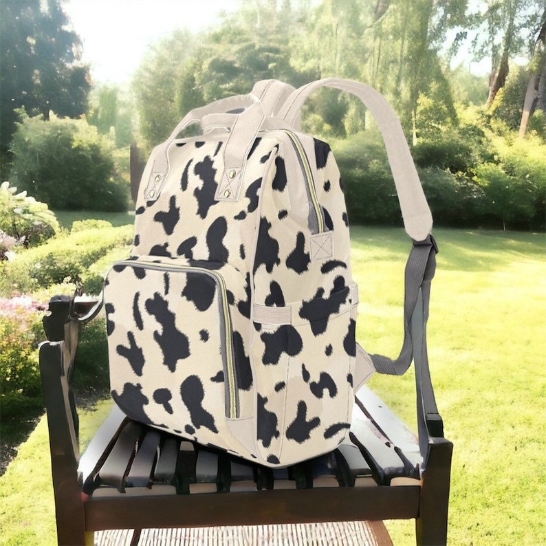 Beige Kuh-Haut-Druck-Windel-Rucksack, niedlicher Kuh-Rucksack mit Multi-Tasche für neue Mütter, Kuh-Rucksack-Geschenk kann viele Dinge tragen Bild 1