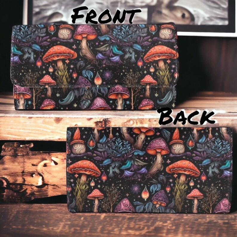 May include: A black wallet with a colorful mushroom and floral pattern. The front of the wallet has the word "FRONT" printed on it. The back of the wallet has the word "BACK" printed on it.
