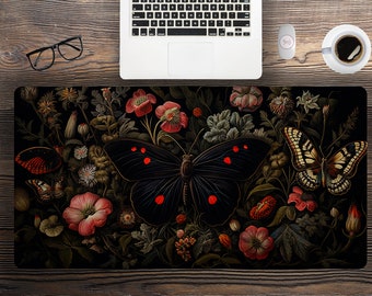 May include: A black butterfly with red spots sits in the center of a dark floral design. The butterfly is surrounded by red, pink, and white flowers, as well as green leaves. The background is a dark, almost black, color.